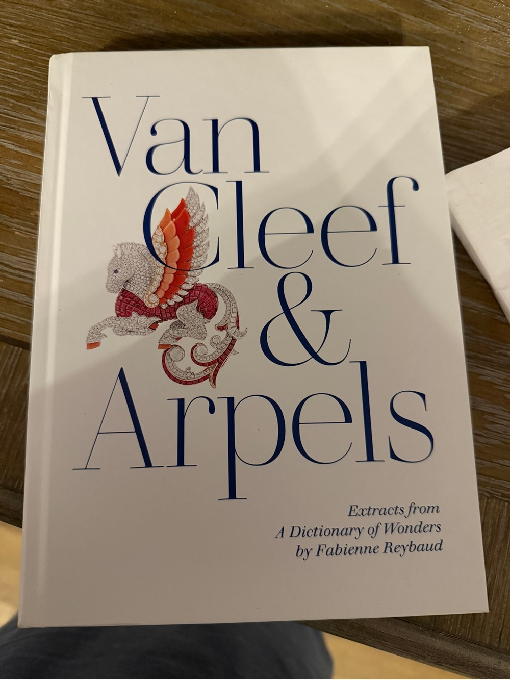 Van Cleef & Arpels White Book with Blue Title and Red Illustration